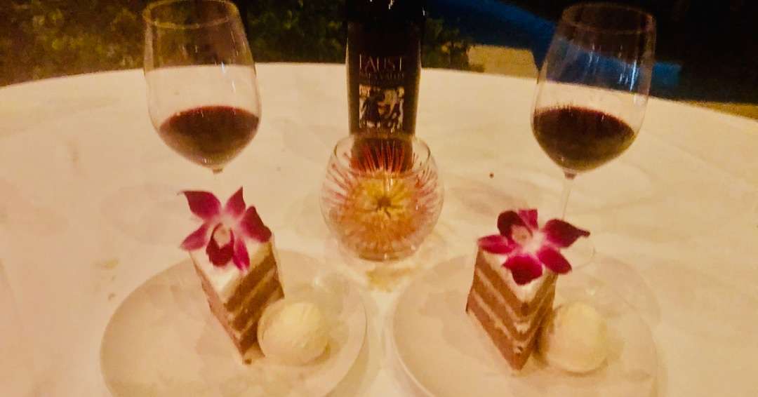 Red wine with cake and orchids